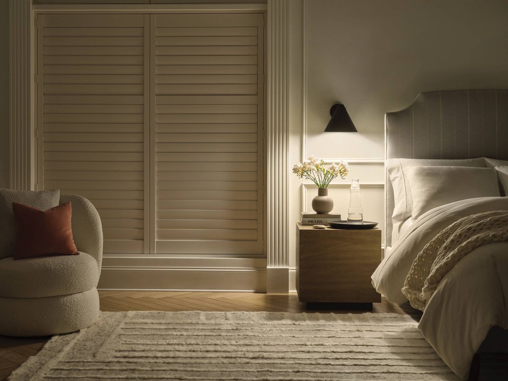 Shutters offer precise light control and privacy in bedrooms.