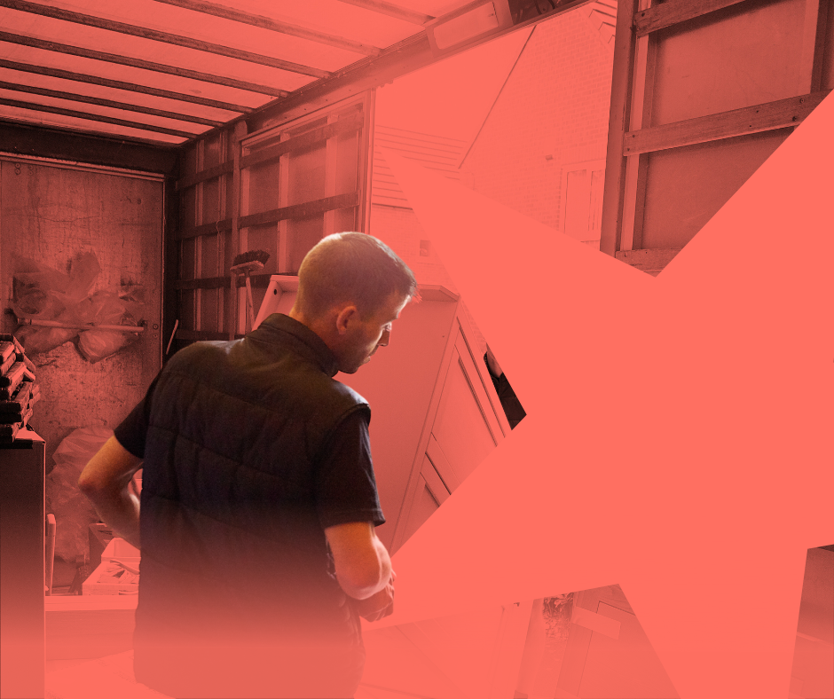 Man in a dark vest looking at art on a white wall in a studio with red overlay.
