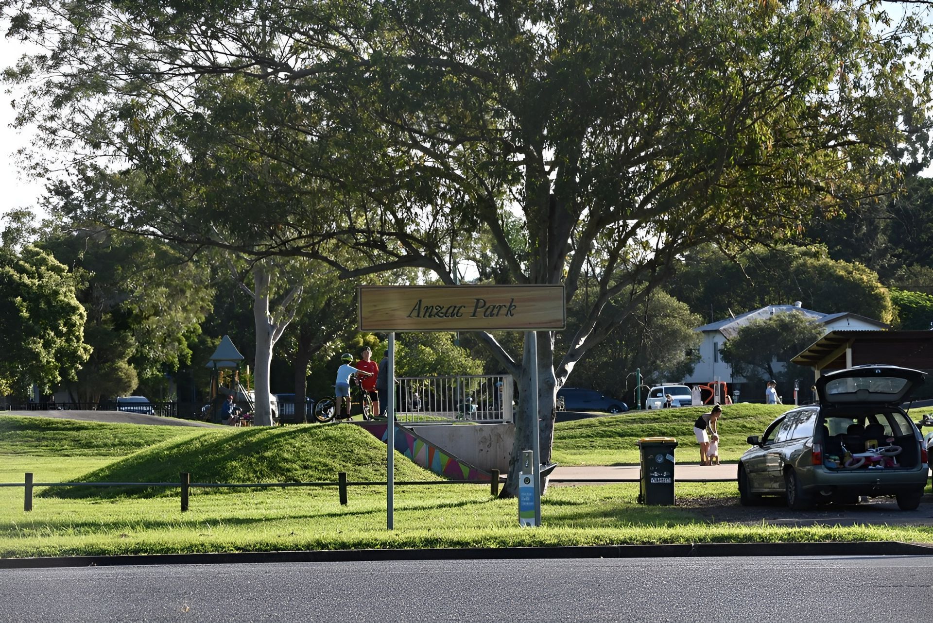 Sign for Ashmore Park, with People and Cars — Walsh Demolition Pty Ltd in Kyogle, NSW