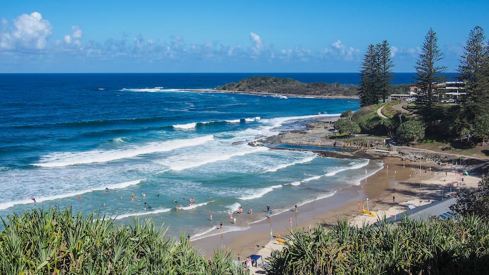 Beach with Waves and People Swimming — Walsh Demolition Pty Ltd in Yamba, NSW