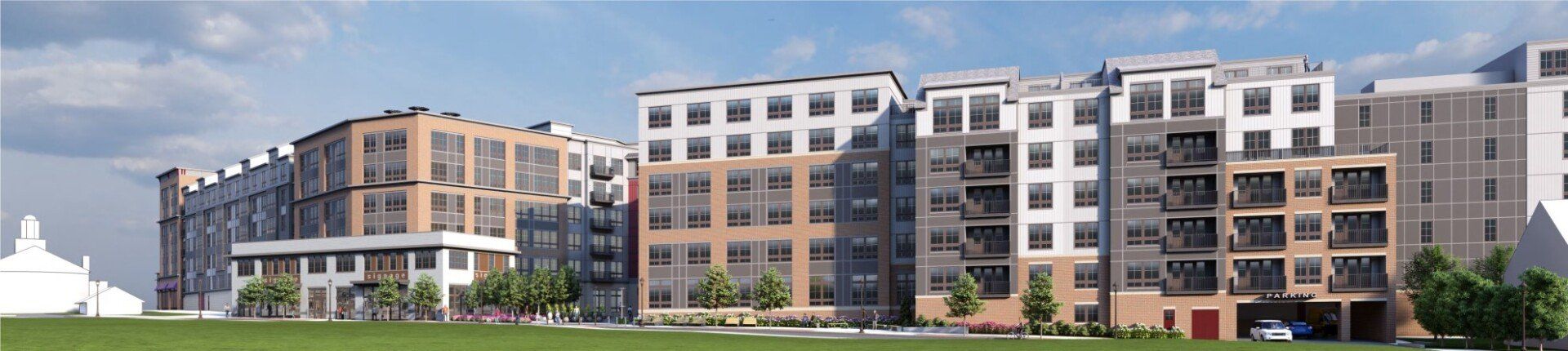 A panoramic rendering of a modern, multi-story apartment complex with brick and grey siding exteriors, set near grass.