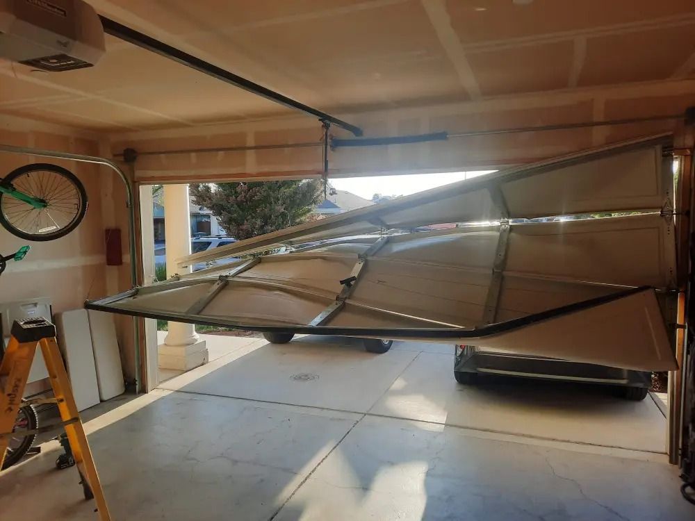 A garage door is open and broken in half.