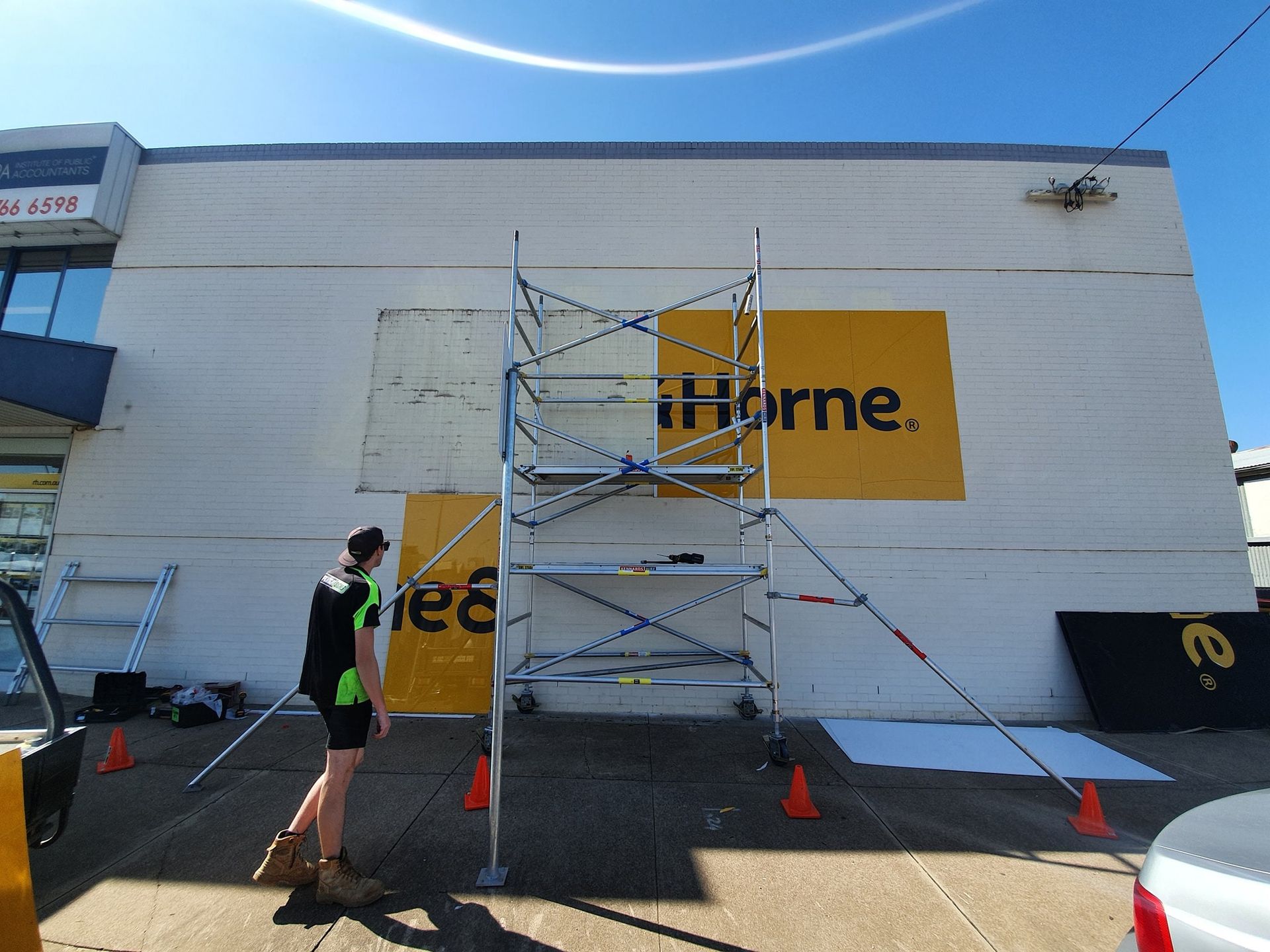 Worker Putting Sign in Shop Front