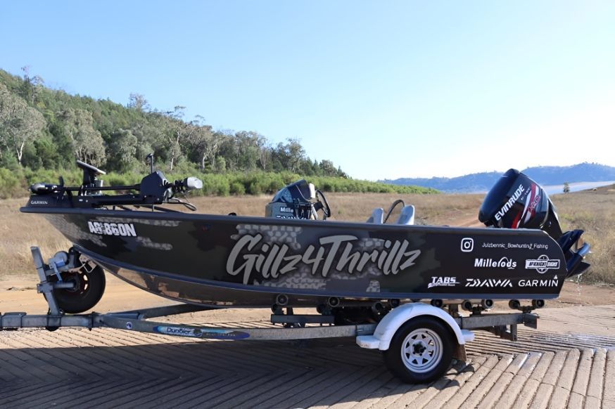 A Boat Is Parked On A Trailer In A Field — McKnight Signs In Hillvue, NSW
