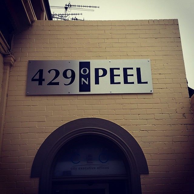 A sign on the side of a building says 429 peel — McKnight Signs In Hillvue, NSW