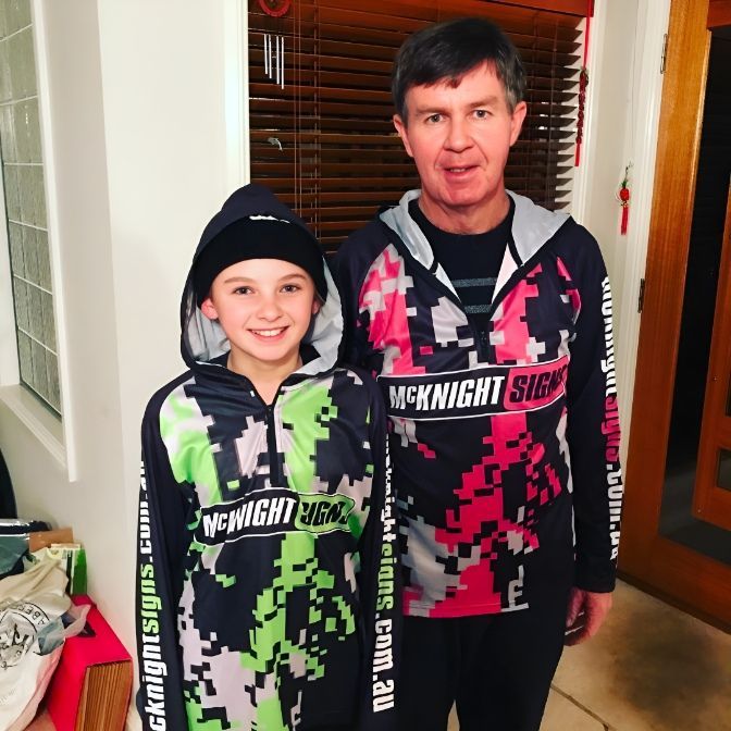 A Man And A Child Wearing Hoodies That Say Mcknight Show — McKnight Signs In Hillvue, NSW
