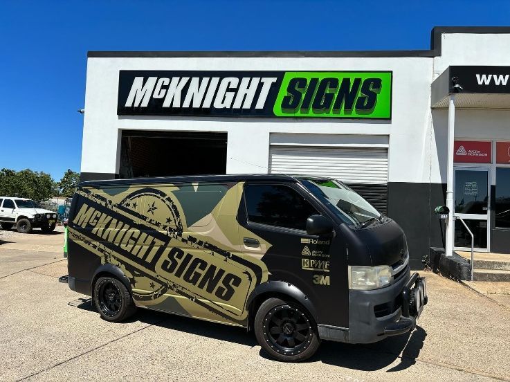 A Van Is Parked In Front Of A Building That Says Mcknight Signs — McKnight Signs In Hillvue, NSW
