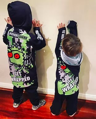 Two Young Boys Are Standing Next To Each Other Wearing Matching Hoodies — McKnight Signs In Armidale, NSW