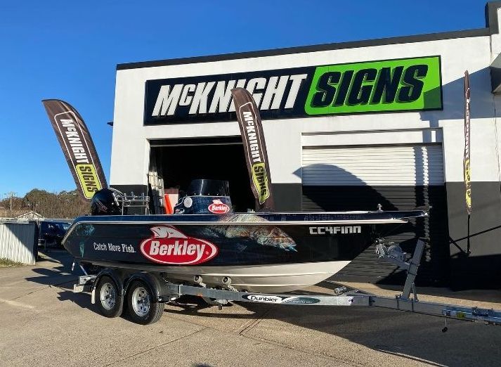 A Boat Is Parked In Front Of A Building That Says Mcknight Signs — McKnight Signs In Hillvue, NSW