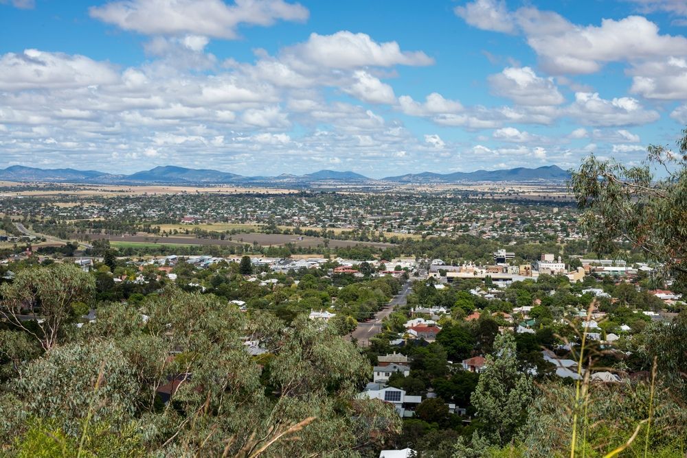 A View Of A City From A Hill With Mountains In The Background — McKnight Signs In Hillvue, NSW