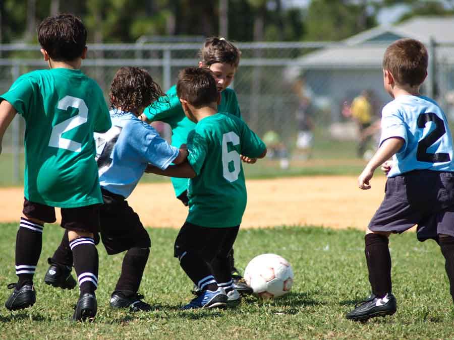 Young Boys playing soccer in an ACI summer cammp.