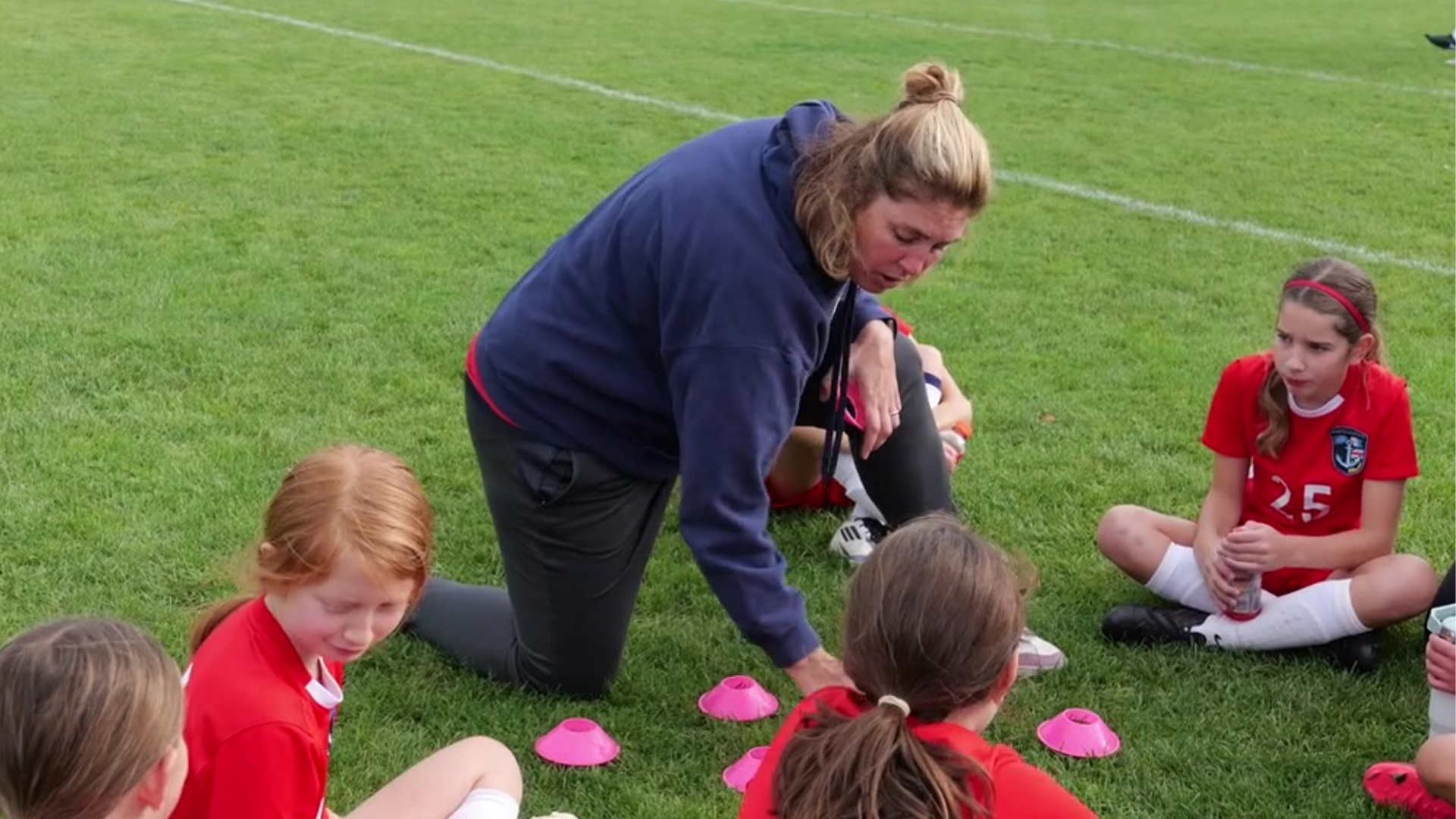 Girls Director and Coach, Yvonna Press instructing and ACI Girls team at halftime.