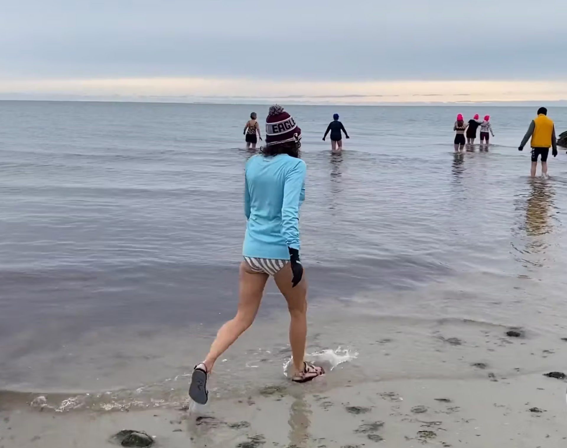 People in shallow water winter dipping