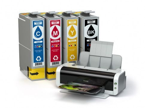 A printer is sitting next to a row of ink cartridges.