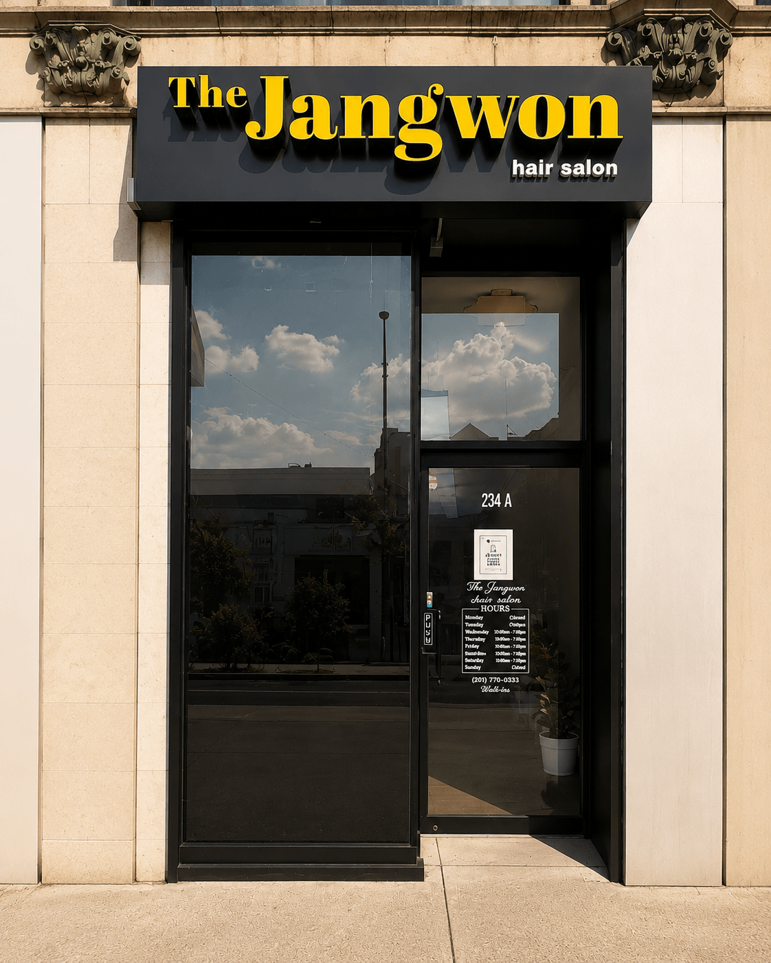 Storefront of The Jangwon hair salon with glass door and black sign