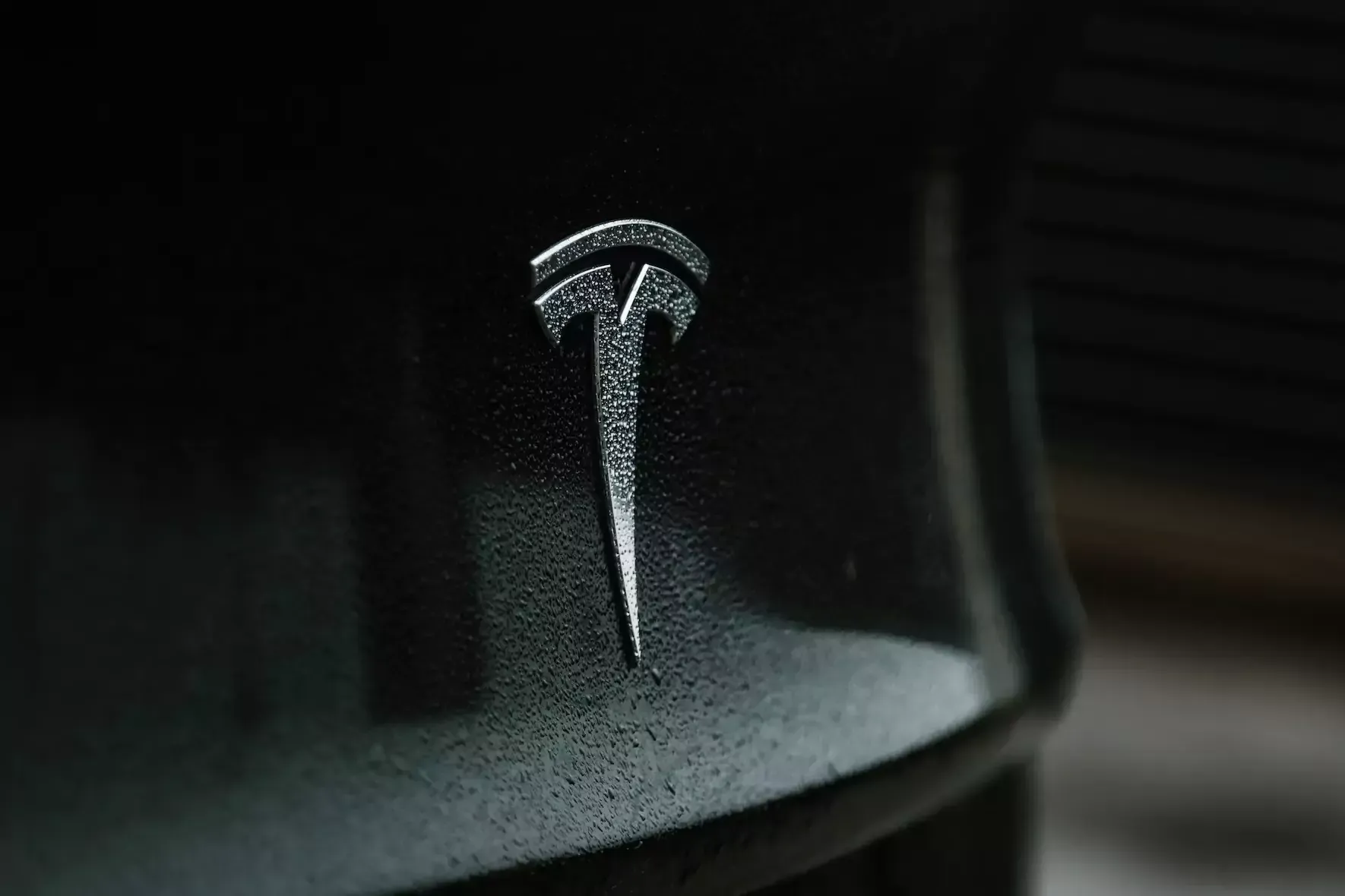 black tesla model x rear badge ceramic coated with water beads