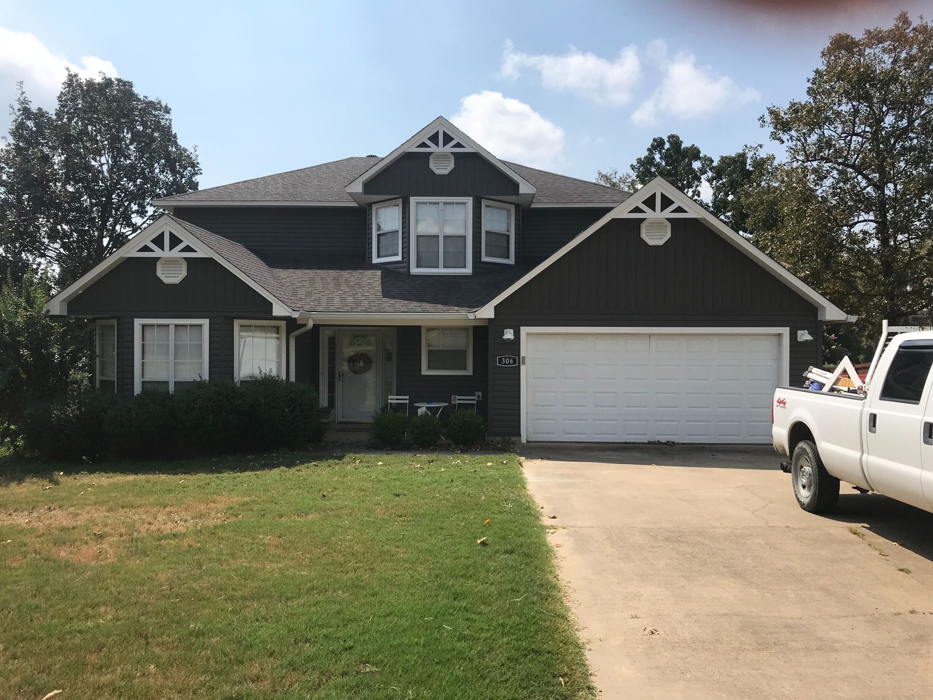 Suburban house with a two-car garage and white pickup truck in the driveway