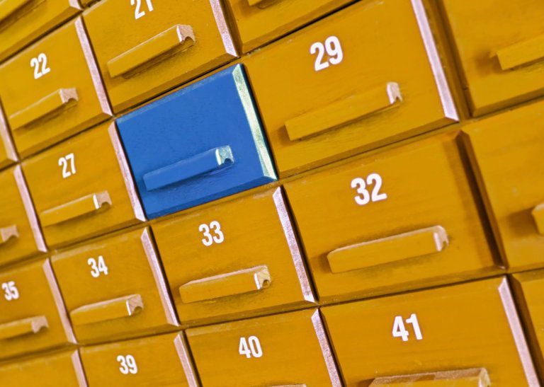 A bunch of yellow drawers with numbers on them