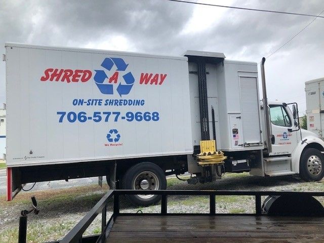 White shredding truck with blue Shred a Way logo