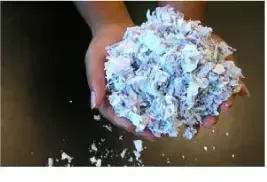 Hands holding shredded paper