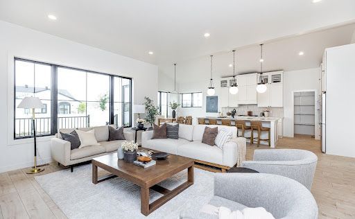 The main level is open and connected, with natural light defining the kitchen, dining and living zones.
