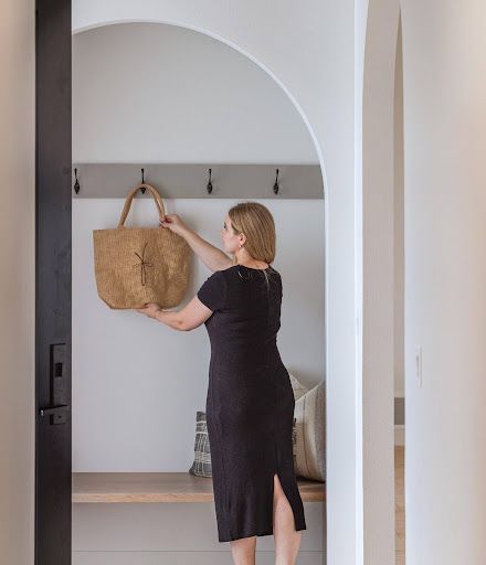 An arched drop zone gives the mudroom a memorable focal point and a practical place to land.
