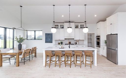 An oversized island creates room for five and keeps conversation at the center of the kitchen.

