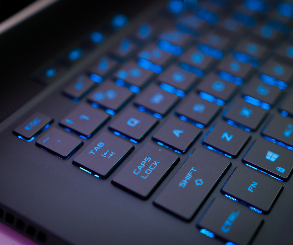 Close-up of a black laptop keyboard with blue backlit keys; 