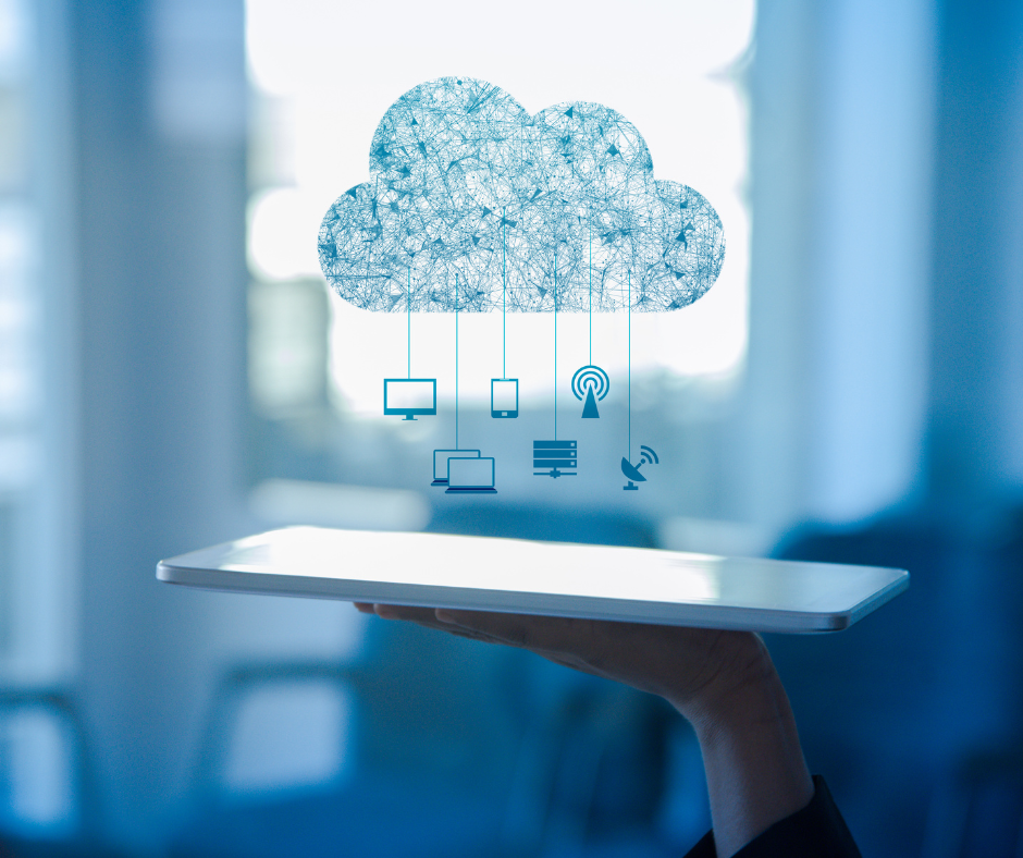 Person holding tablet with digital cloud and connected devices.