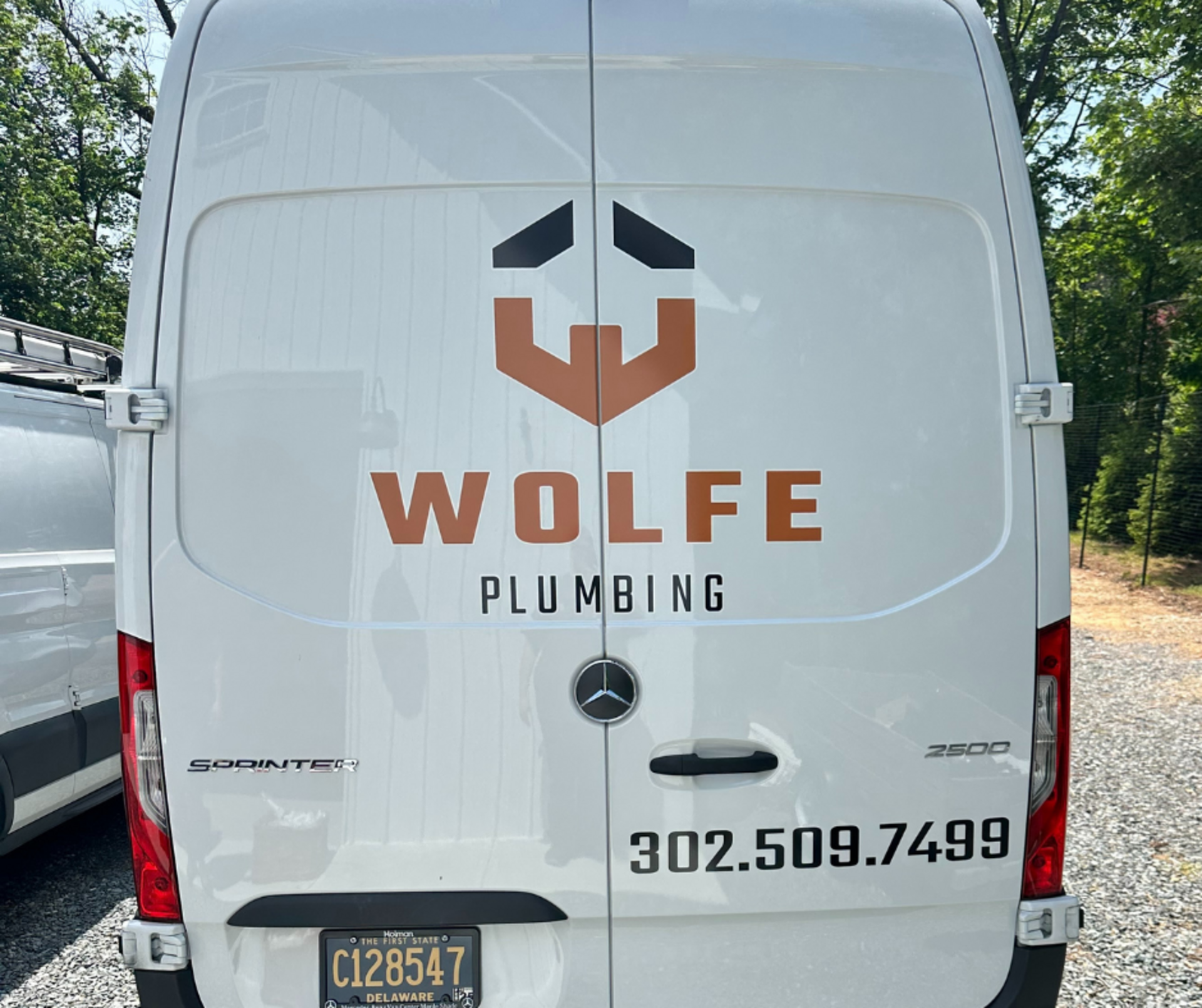 Man Holding A Pipe Hose — Hockessin, DE — Wolfe Plumbing LLC