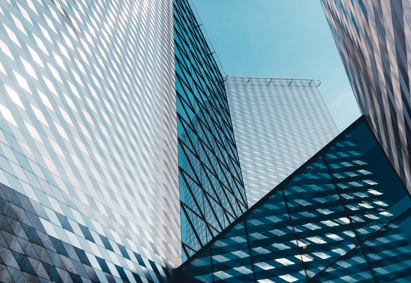 Looking up at a tall building with a blue sky in the background.