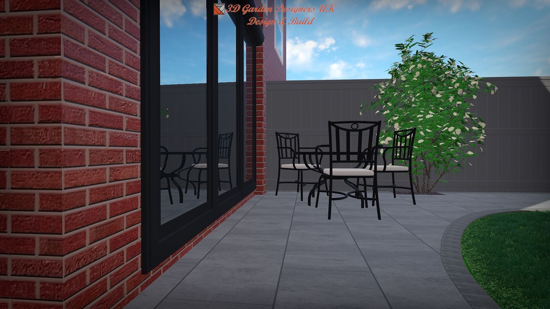 Patio with brick wall, glass doors reflecting sky, metal chairs, and a bush on a stone patio.