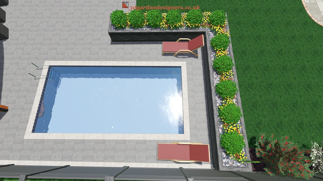 Overhead view of a rectangular pool with two red lounge chairs and a stone planter with green bushes and flowers.