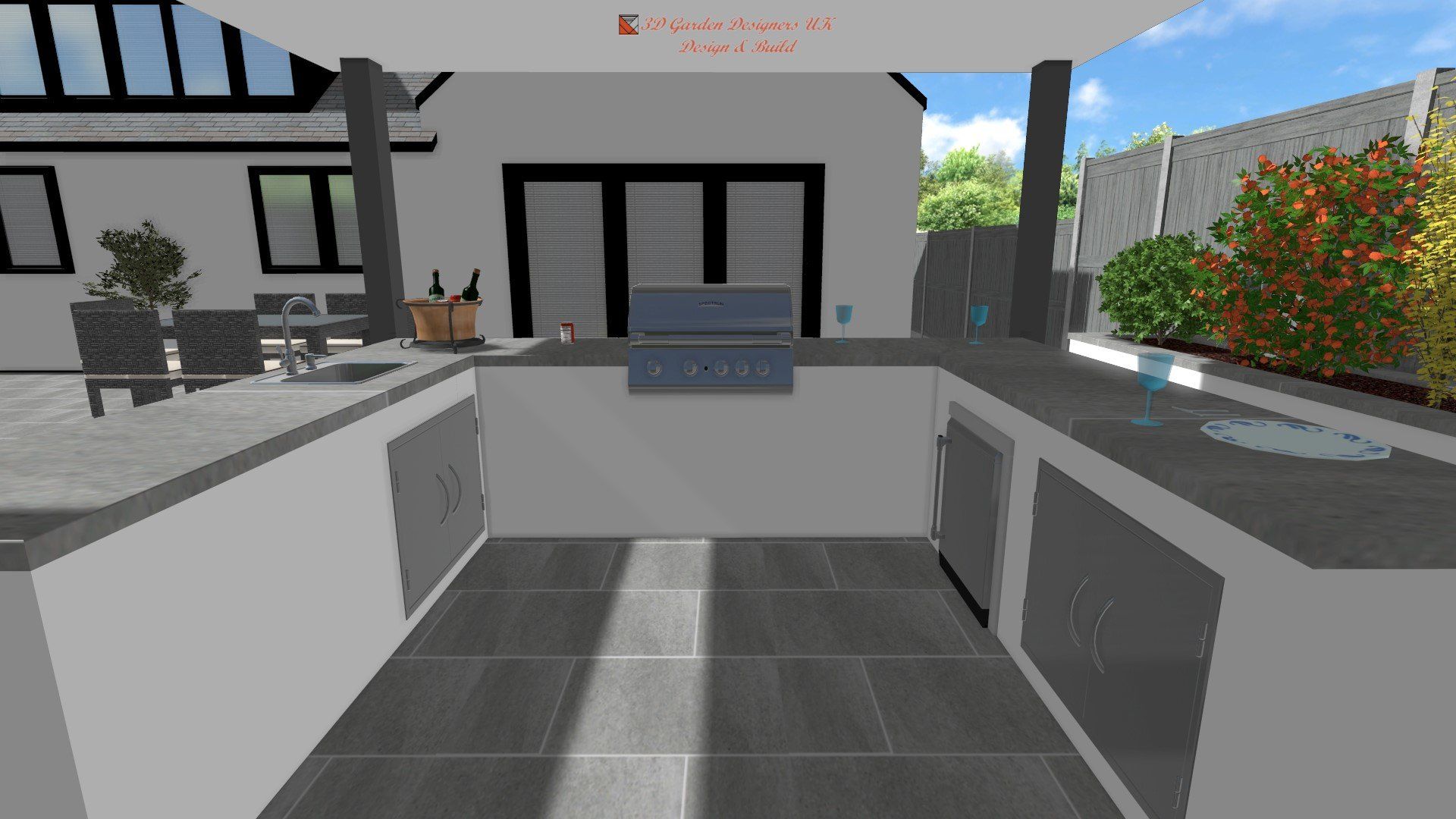 Outdoor kitchen with a grill, countertop, and cabinets. Patio and house in the background. Sunny day.