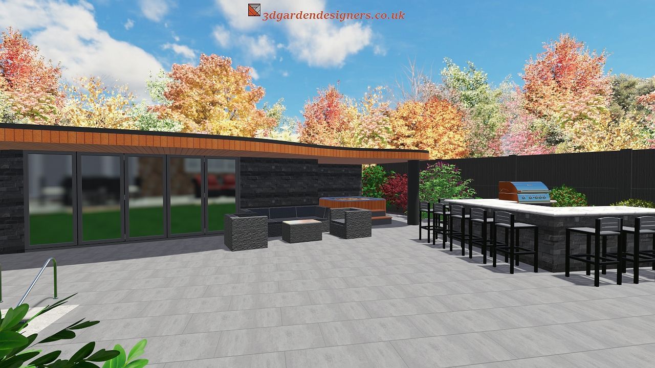 Outdoor patio with bar, seating, grill, and lush landscaping under a blue sky with fall foliage.