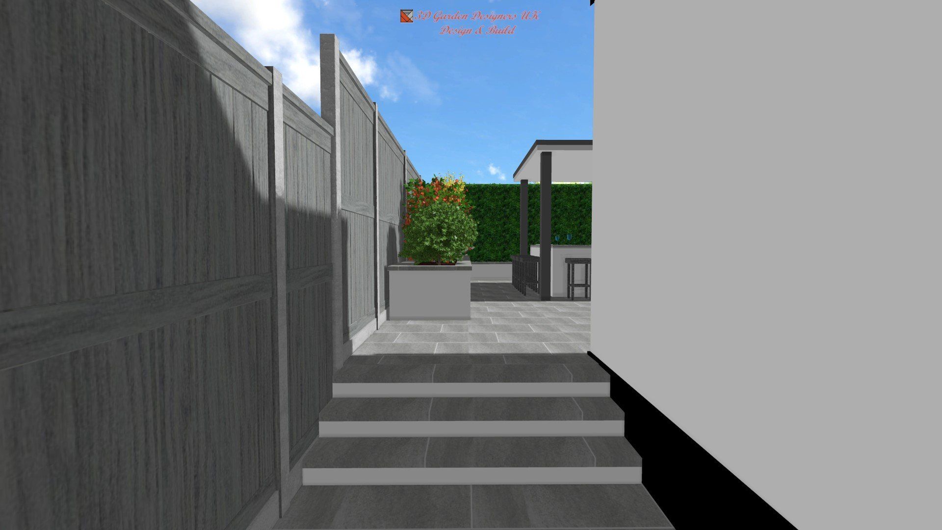View from steps leading to a modern backyard with a hedge, patio, and plant in a square planter.