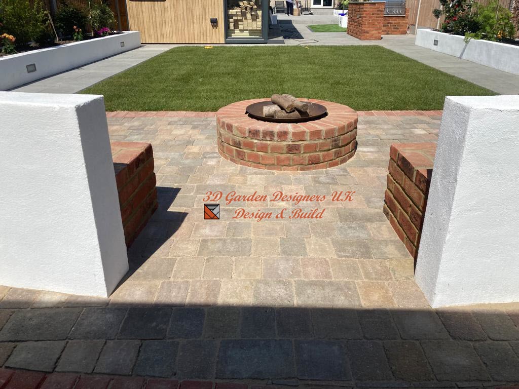 Patio with brick fire pit, seating, lawn, and white walls.