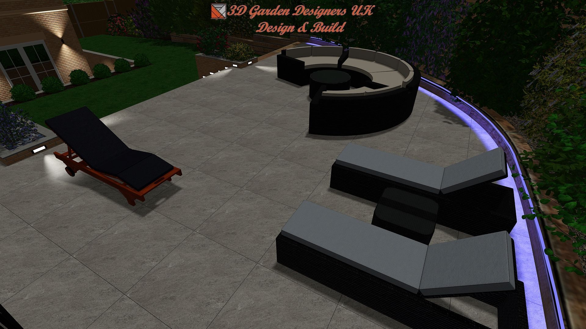 Outdoor patio with black furniture, including a chaise lounge and curved sofa, with a low wall and a garden.