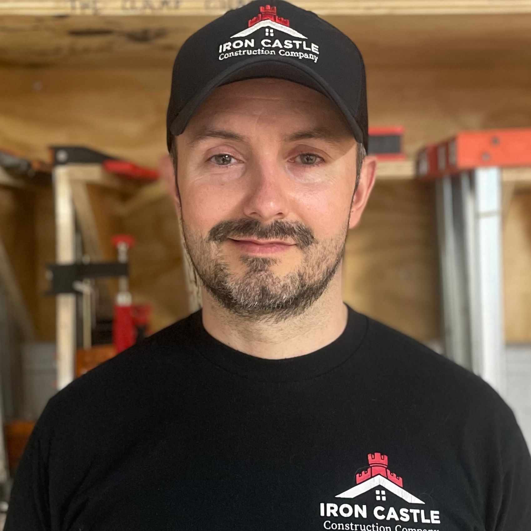 A man wearing a black shirt and cap with 