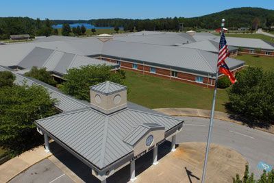 An aerial view of a large building with a flag flying in front of it.