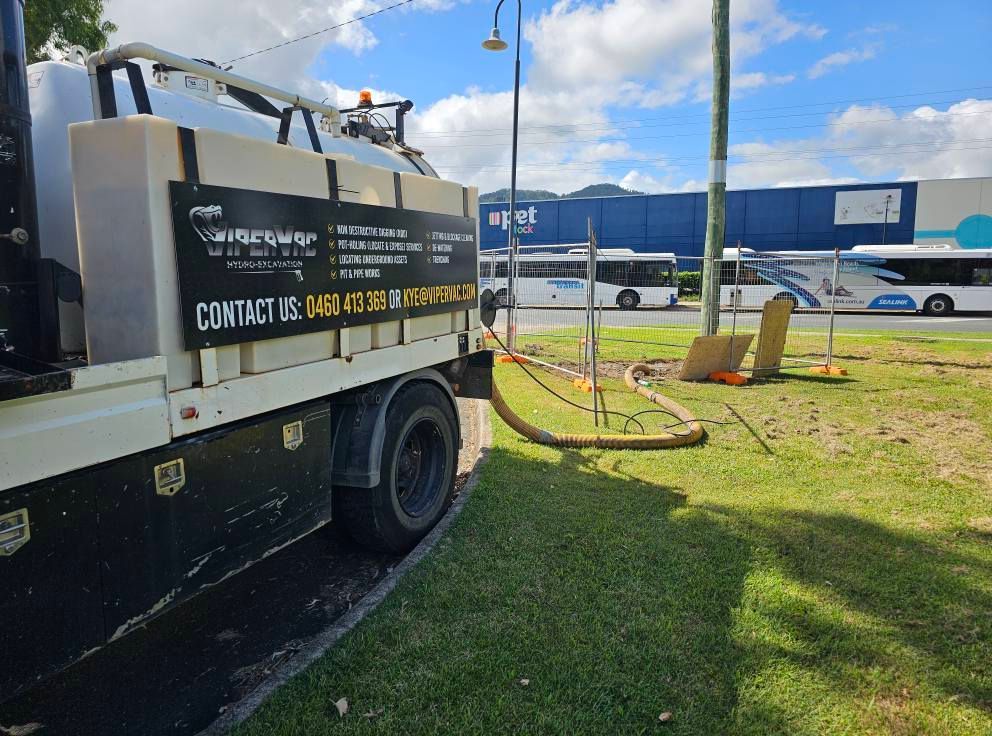 White Vacuum Truck Parked on Grass With a Hose Extended — ViperVac Solutions PTY LTD in Cannonvale, QLD