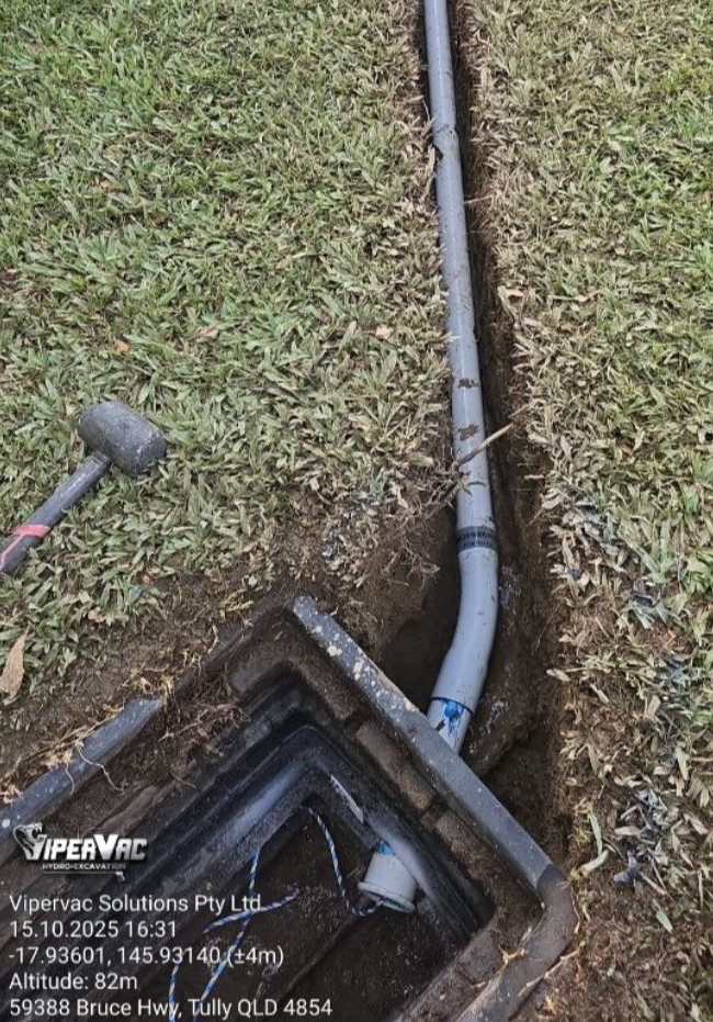 A Man Is Fixing A Pipe In A Puddle Of Water — ViperVac Solutions PTY LTD in Bowen, QLD