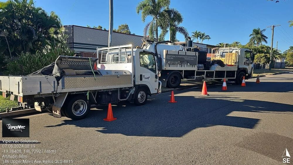A Row Of Trucks Are Parked On The Side Of The Road — ViperVac Solutions PTY LTD in Cannonvale, QLD