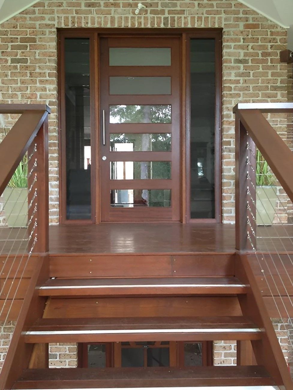 A Brick Building With a Wooden Door and Deck — D.J. Decks in Sawtell, NSW