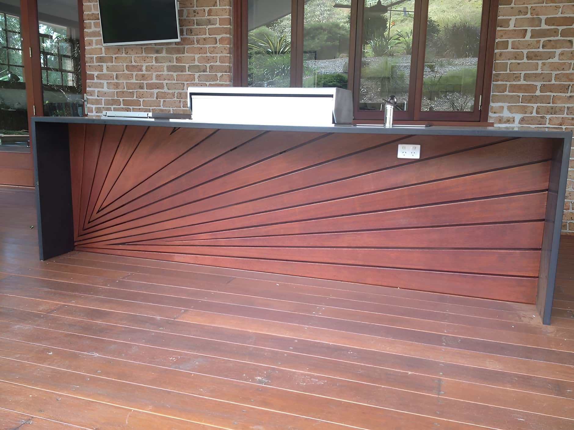 A Wooden Counter With a Brick Wall Behind It — D.J. Decks in Emerald Beach, NSW
