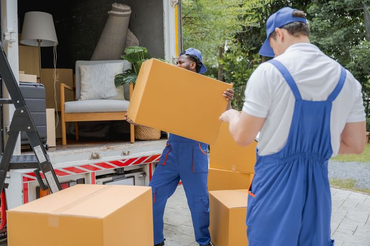 Man Moving Cardboard Boxes - Cambridge, MN - C & J Relocation Services, LLC Man Moving Cardboard Boxes - Cambridge, MN - C & J Relocation Services, LLC