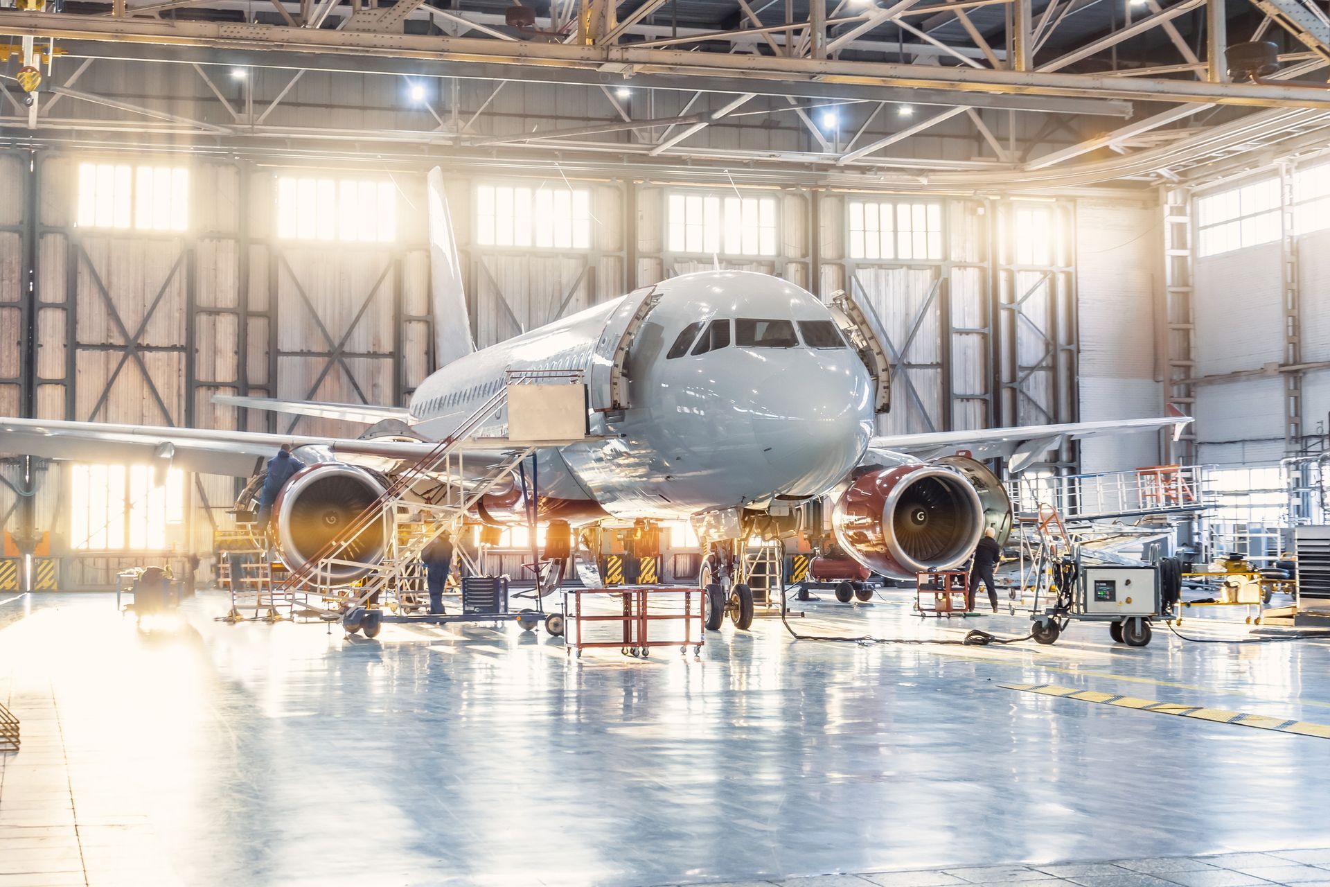 A large passenger jet is being built in a hangar.