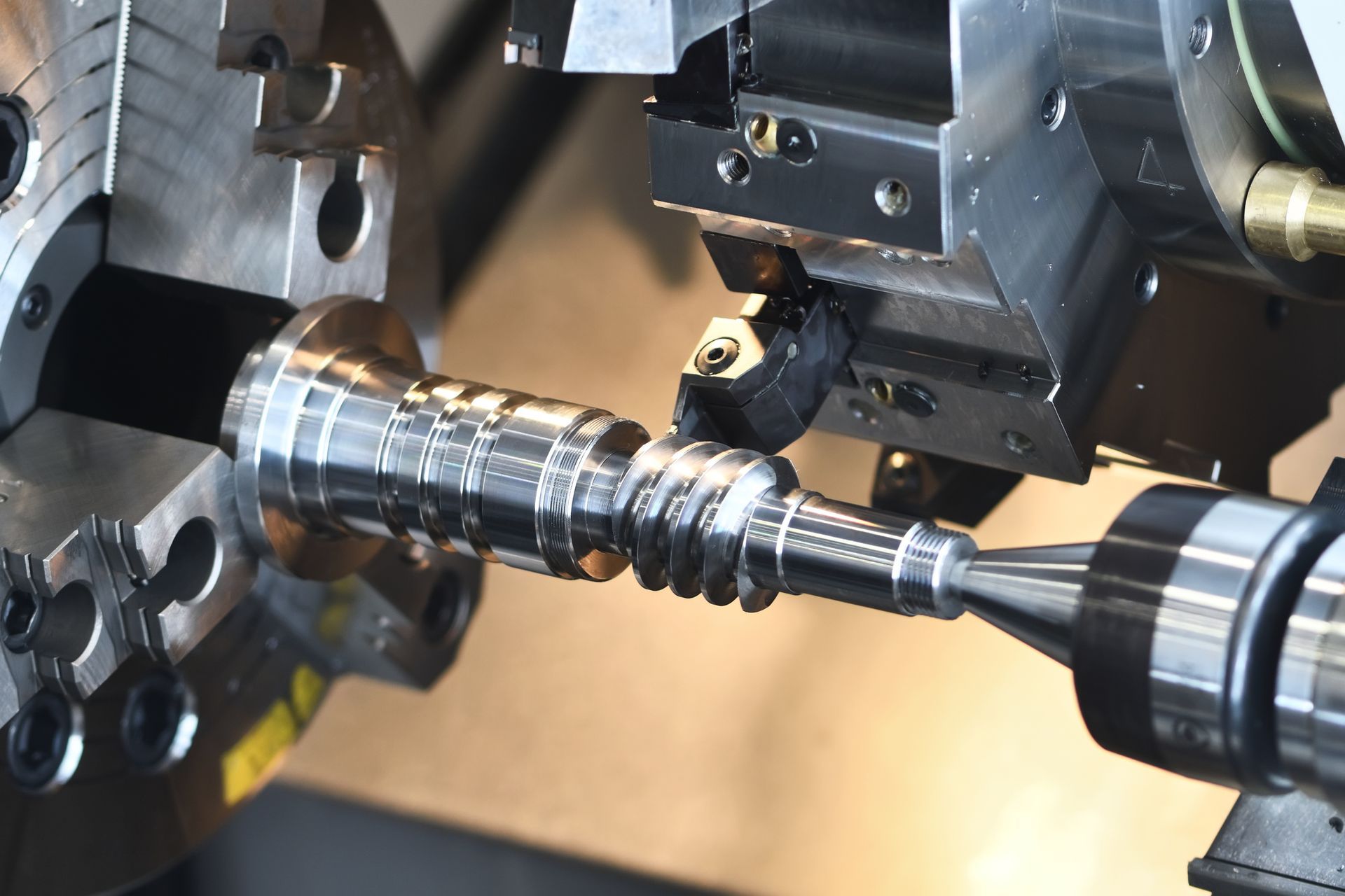 A machine is cutting a piece of metal on a lathe.