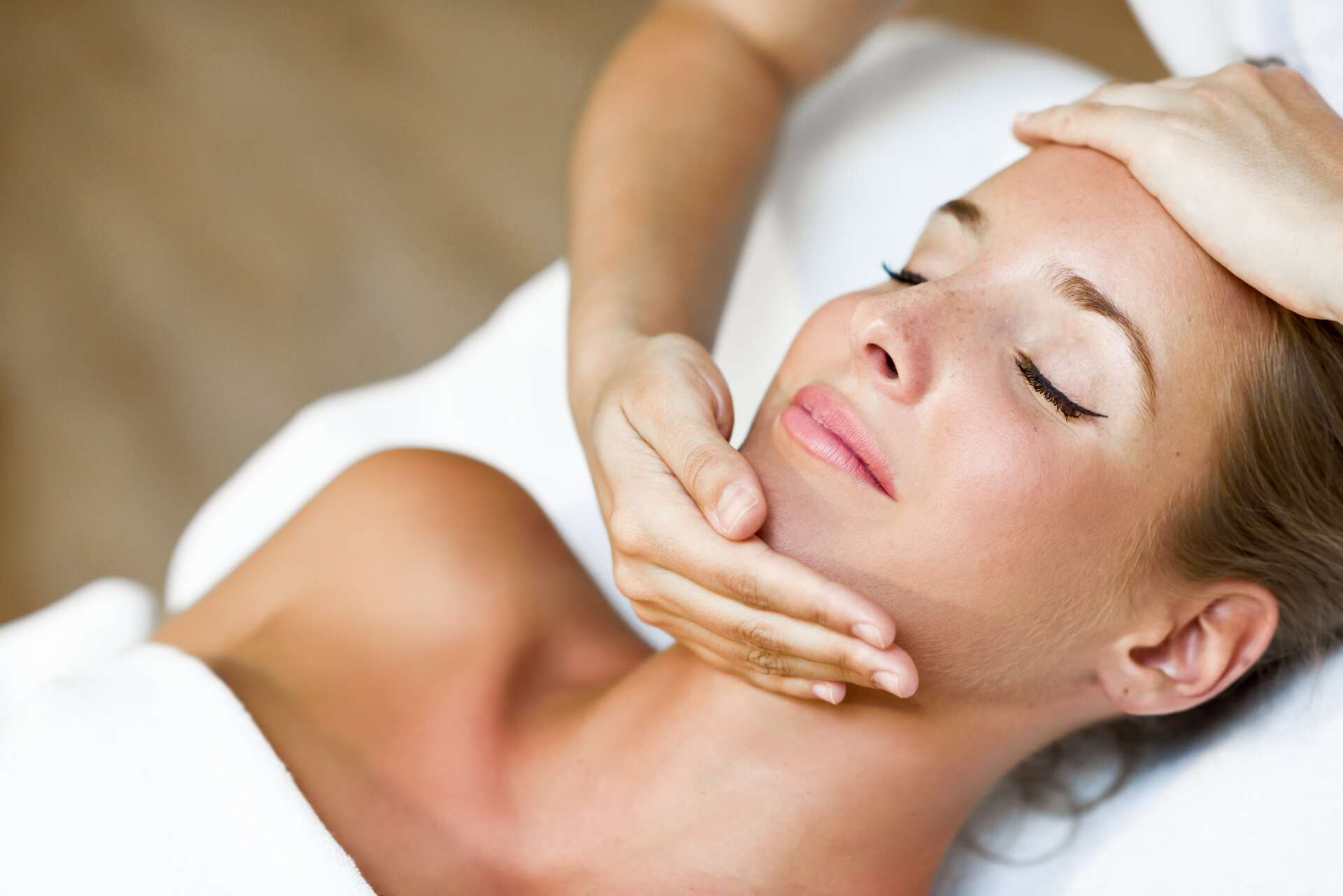 young-woman-receiving-head-massage-spa-center