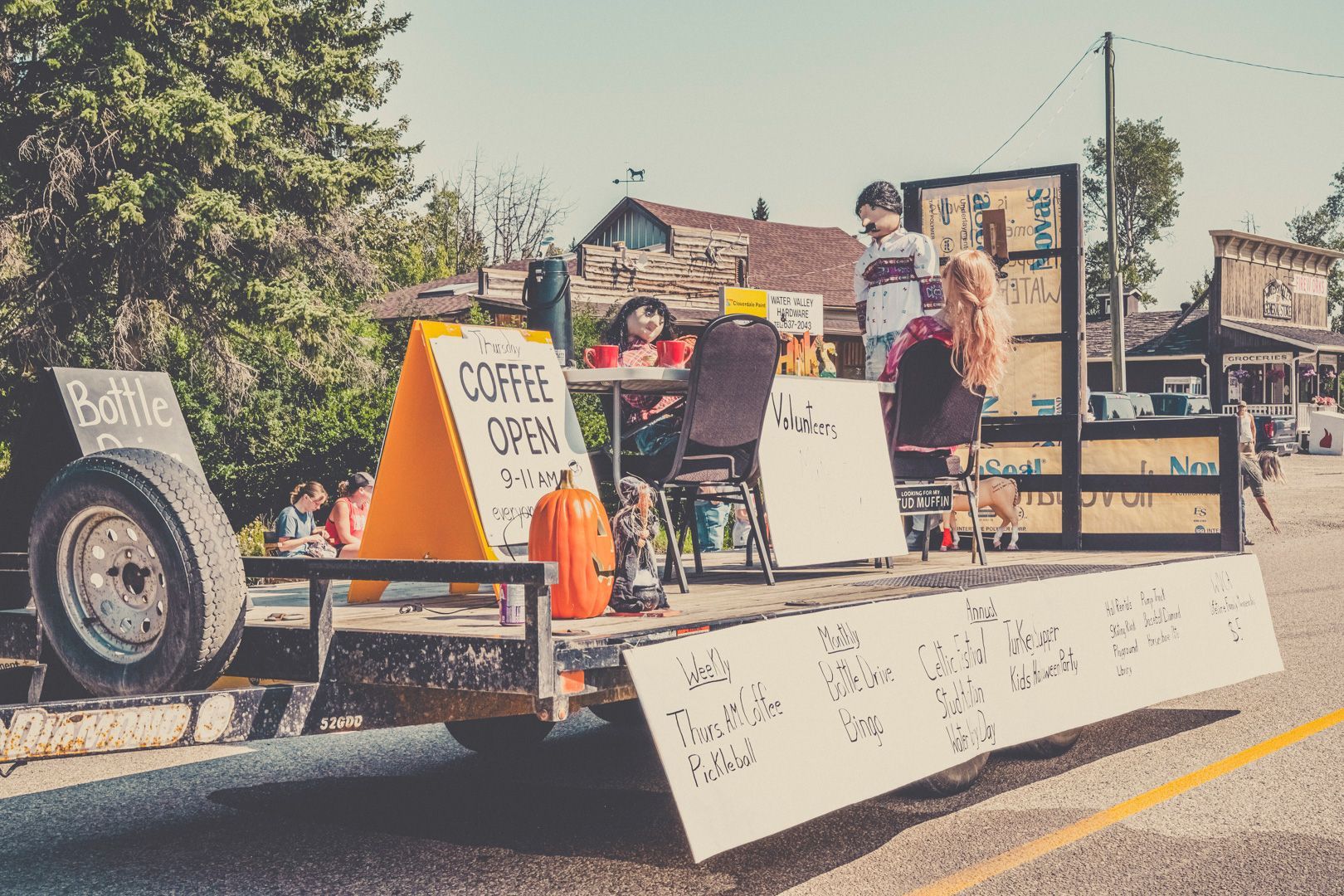 A parade float styled as an outdoor cafe, featuring seating, a 